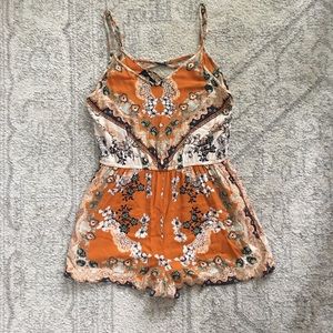 Angie • boutique orange patterned romper
